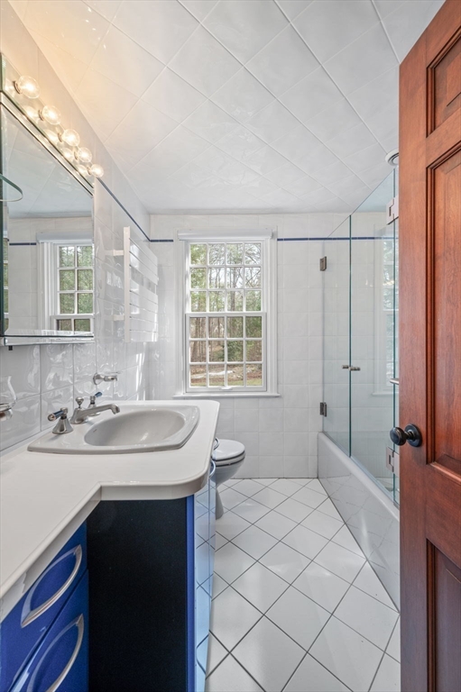 15 Woodland Road Boxford, MA 01921 - Photo 23 of 38 a bathroom with a sink toilet and mirror