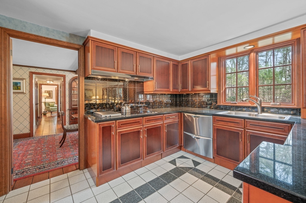 15 Woodland Road Boxford, MA 01921 - Photo 8 of 38 a kitchen with stainless steel appliances granite countertop a stove a sink and a microwave