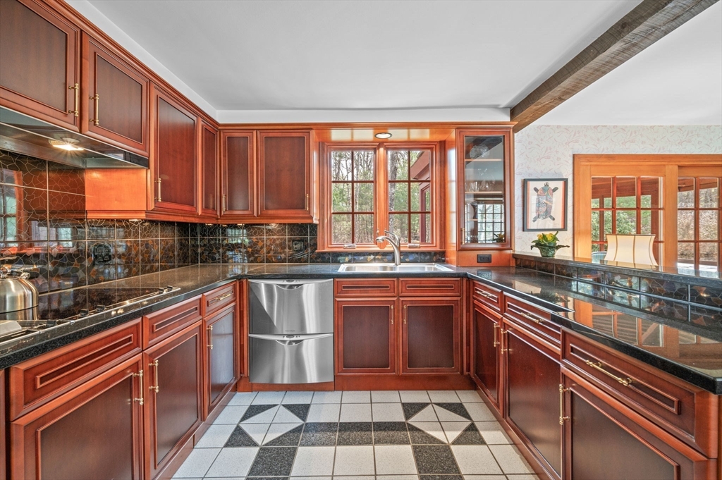 15 Woodland Road Boxford, MA 01921 - Photo 9 of 38 a kitchen with stainless steel appliances granite countertop a stove sink and cabinets