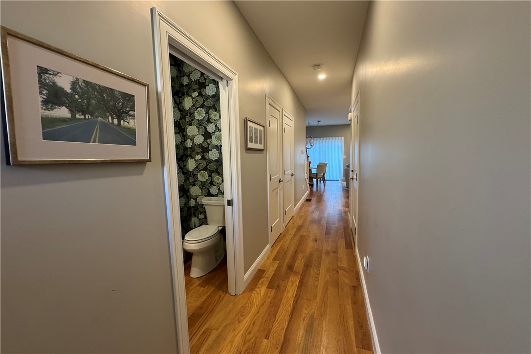 25 Franklin Road, Unit 1 East Greenwich, RI 02818 - Photo 11 of 38 Looking towards main living space - half bath on the left, large coat closet on the left, door to garage on right, enrance to lower level basement on the left.