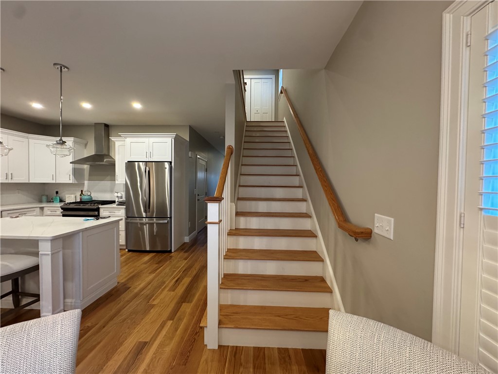 25 Franklin Road, Unit 1 East Greenwich, RI 02818 - Photo 13 of 38 View of the stairway leading to the bedrooms. Let't head up to the bedrooms - 2 huge bedrooms each with their own full bathrooms and walk in closets!