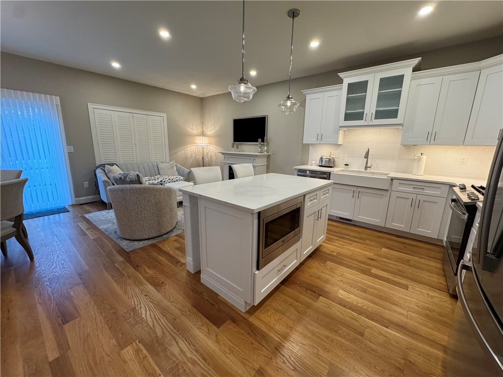 25 Franklin Road, Unit 1 East Greenwich, RI 02818 - Photo 4 of 38 Huge open concept kitchen, living and dining with gorgeous wide plank wood floors.