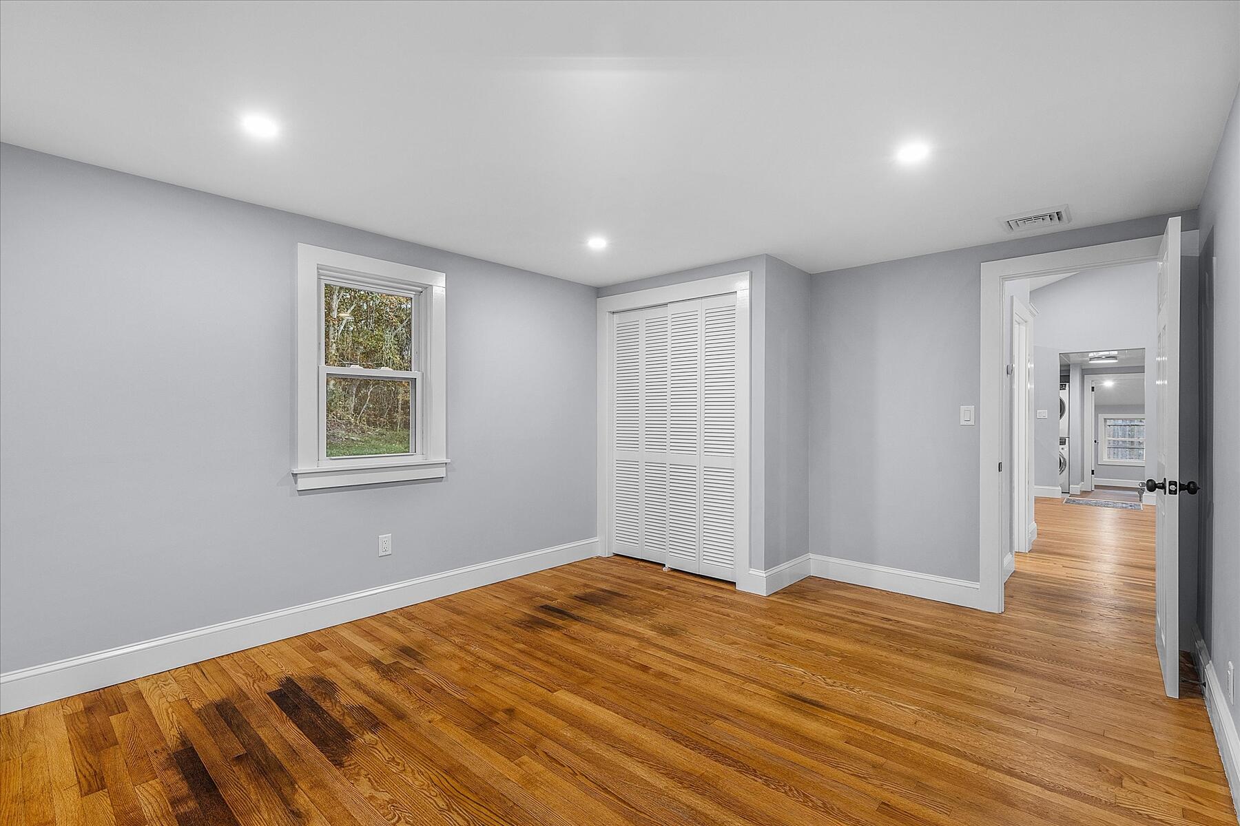 15 Shannon Road Harwich, MA 02645 - Photo 14 of 21 a view of empty room with wooden floor and fan