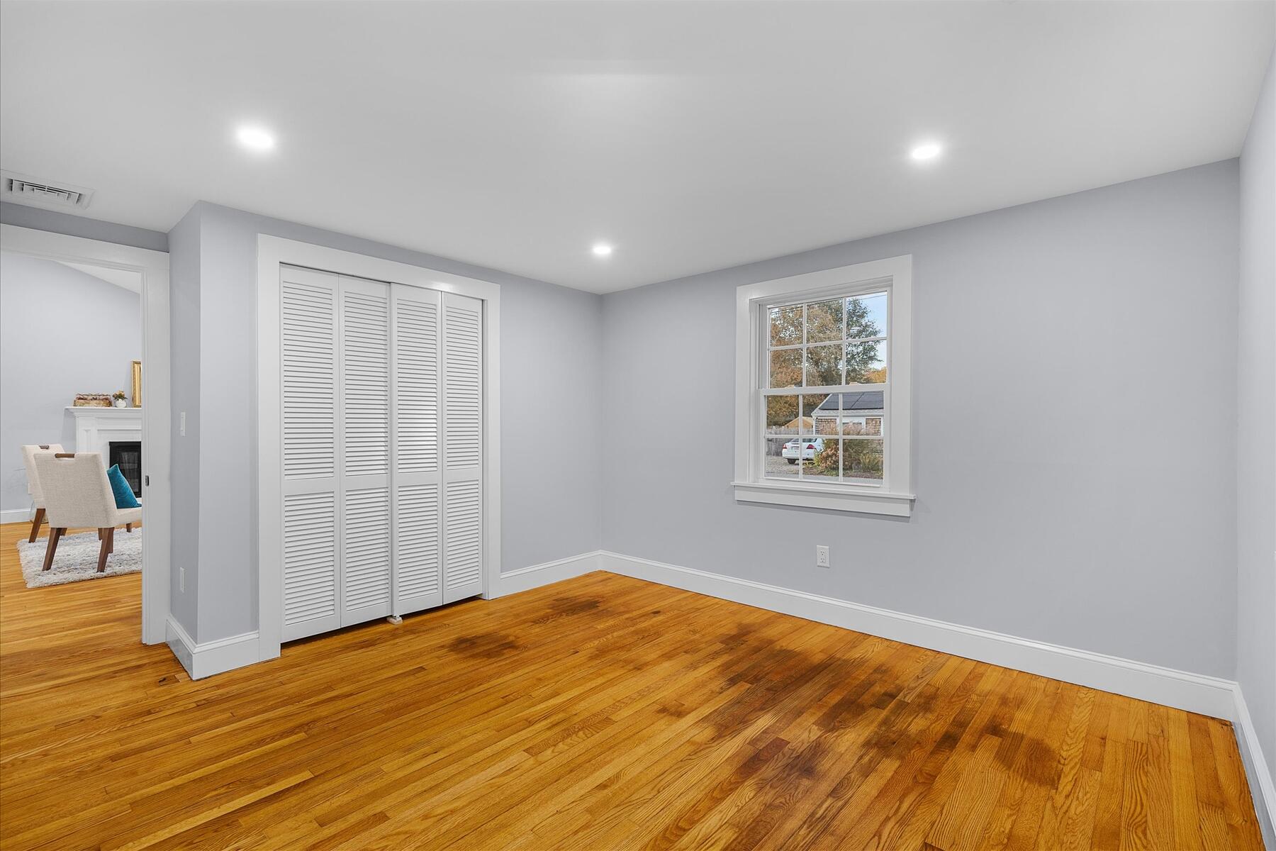 15 Shannon Road Harwich, MA 02645 - Photo 16 of 21 a view of empty room with wooden floor and fan