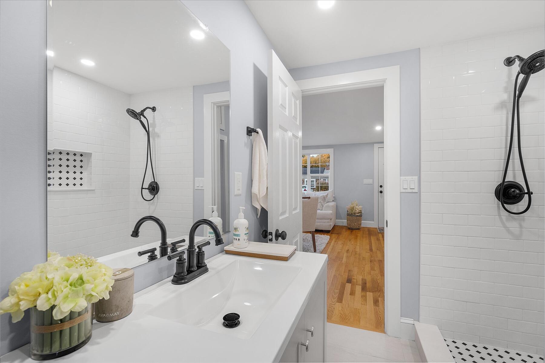 15 Shannon Road Harwich, MA 02645 - Photo 18 of 21 a bathroom with a sink mirror and a shower