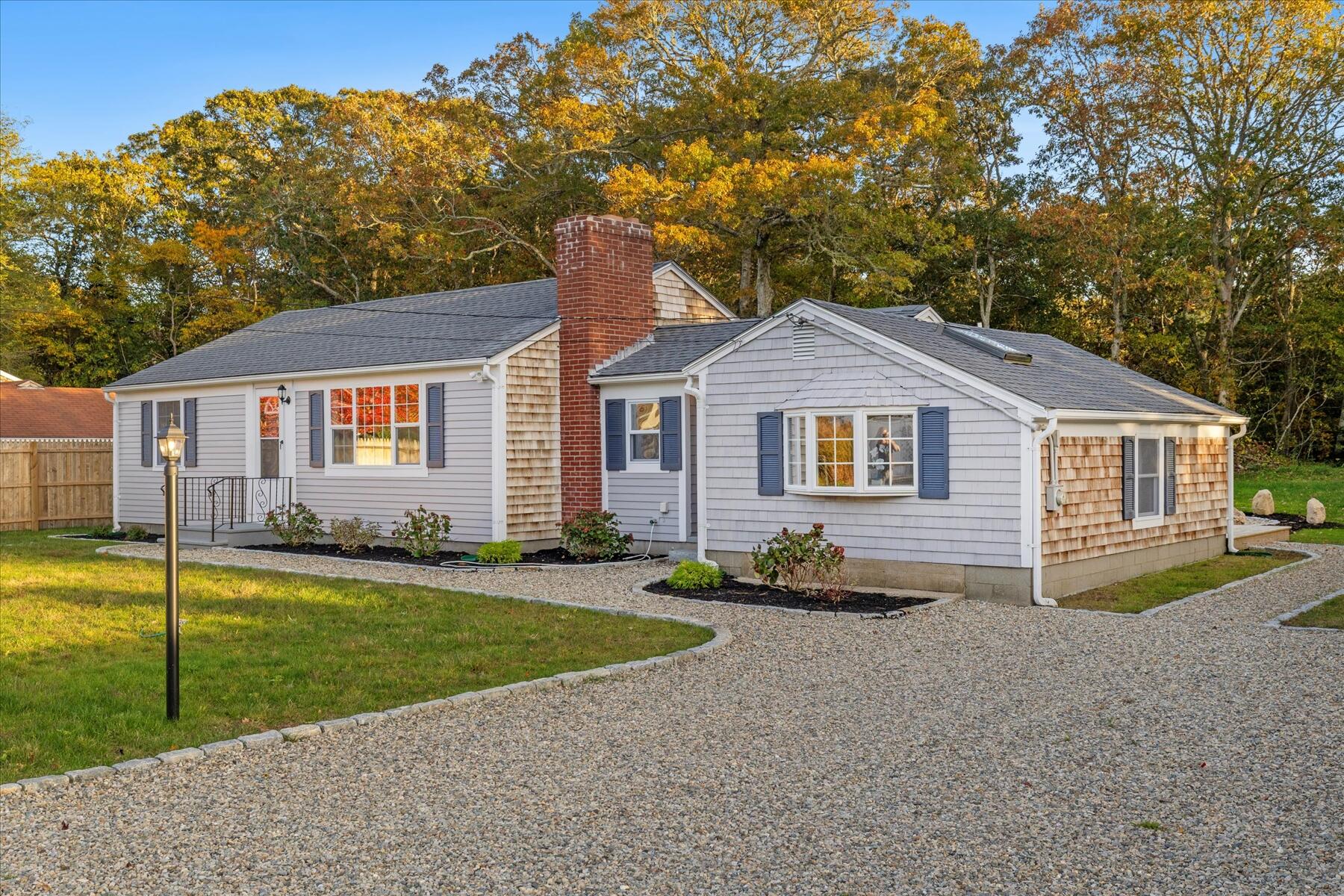15 Shannon Road Harwich, MA 02645 - Photo 3 of 21 a front view of a house with a yard and garage