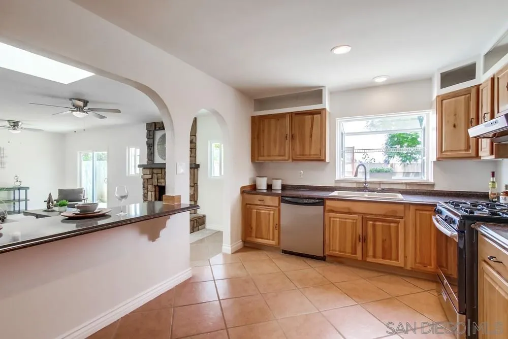 2051 Ridge View Drive San Diego, CA 92105 - Photo 18 of 51 a large kitchen with stainless steel appliances granite countertop a sink and a stove