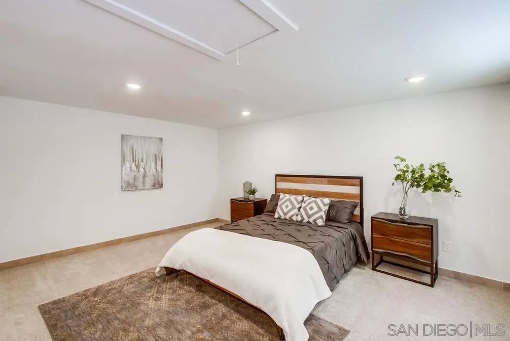 2051 Ridge View Drive San Diego, CA 92105 - Photo 25 of 51 a bedroom with a bed and a potted plant