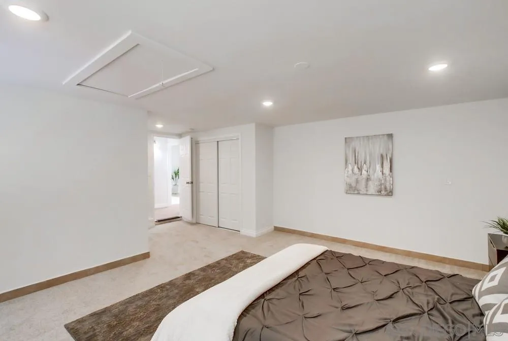 2051 Ridge View Drive San Diego, CA 92105 - Photo 27 of 51 a bedroom with a bed and a painting on the wall