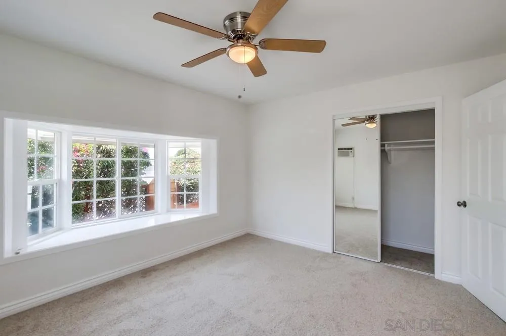 2051 Ridge View Drive San Diego, CA 92105 - Photo 36 of 51 an empty room with chandelier fan and windows