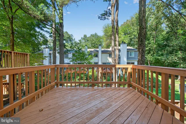 a view of balcony with wooden floor and fence
