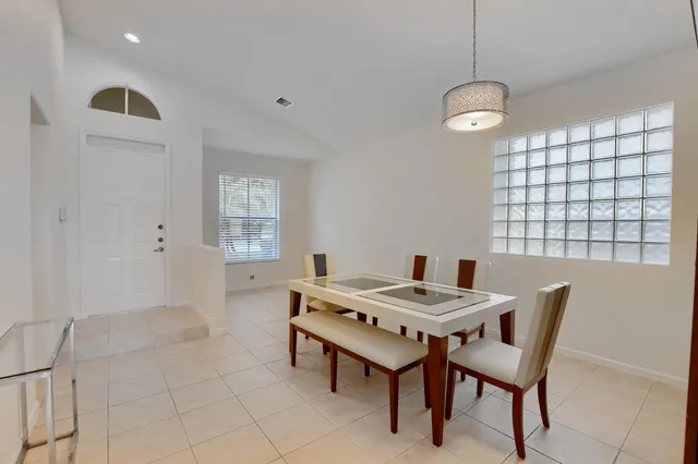 a view of a dining room with furniture and window