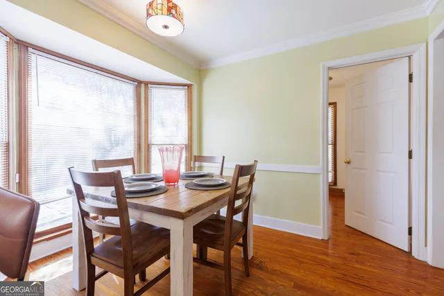 a view of a dining room with furniture window and wooden floor