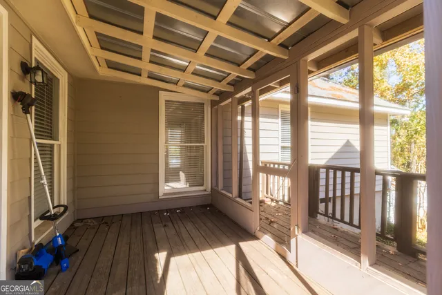a view of outdoor space with wooden floor and windows
