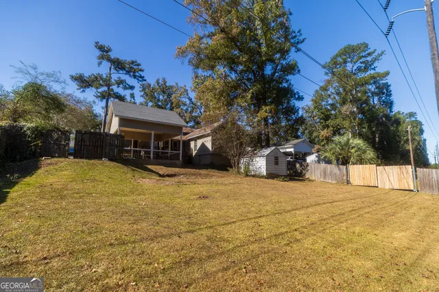 a view of a house with a yard and sitting area