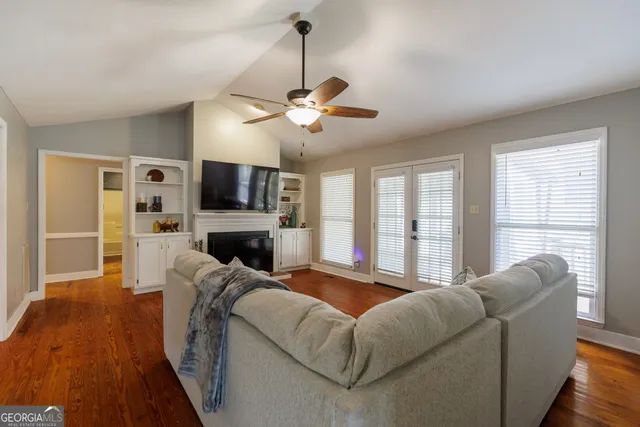 a living room with furniture a fireplace and a flat screen tv