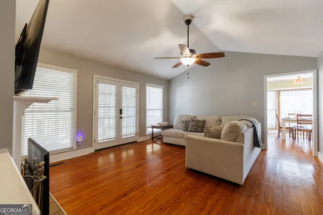 a living room with furniture and wooden floor