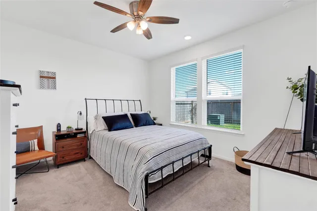 a bedroom with a bed couch and window