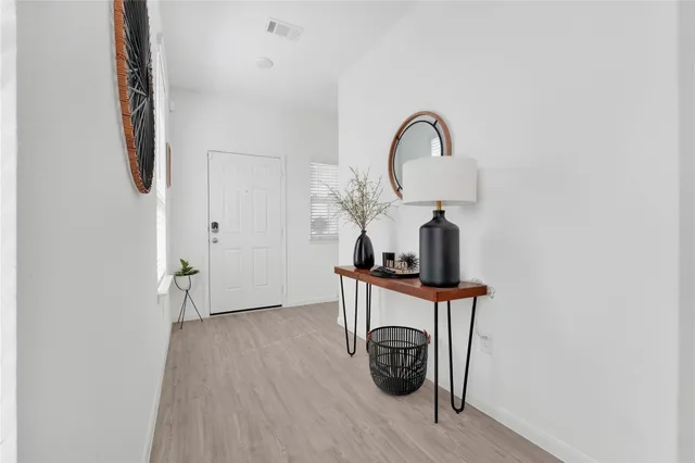 a view of a room that has a table and chairs in it