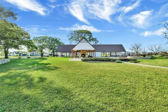 a house view with swimming pool and trees in the background