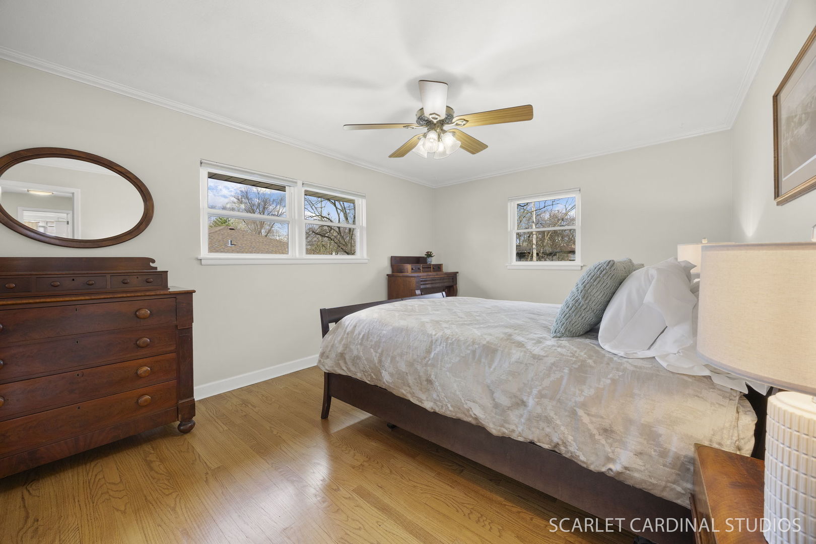 9 Notre Dame Drive Naperville, IL 60540 - Photo 16 of 24 a spacious bedroom with a bed a dresser and a chandelier