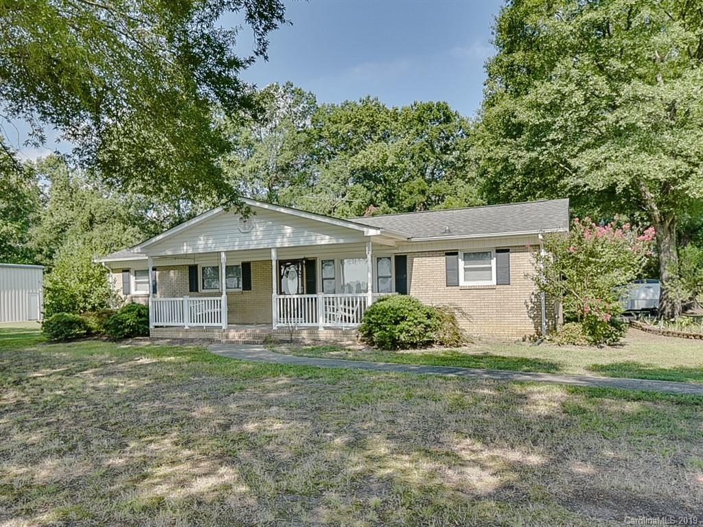 507 Sikes Mill Road Monroe, NC 28110 - Photo 1 of 40 a front view of a house with a garden