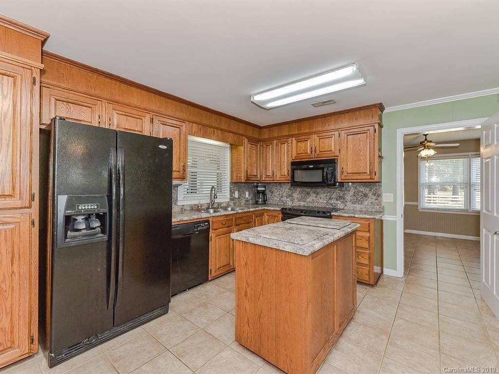 507 Sikes Mill Road Monroe, NC 28110 - Photo 11 of 40 a kitchen with stainless steel appliances granite countertop a refrigerator oven a sink and dishwasher