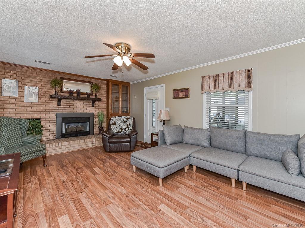 507 Sikes Mill Road Monroe, NC 28110 - Photo 18 of 40 a living room with furniture and a fireplace