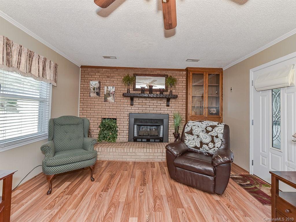 507 Sikes Mill Road Monroe, NC 28110 - Photo 21 of 40 a living room with furniture and a fireplace