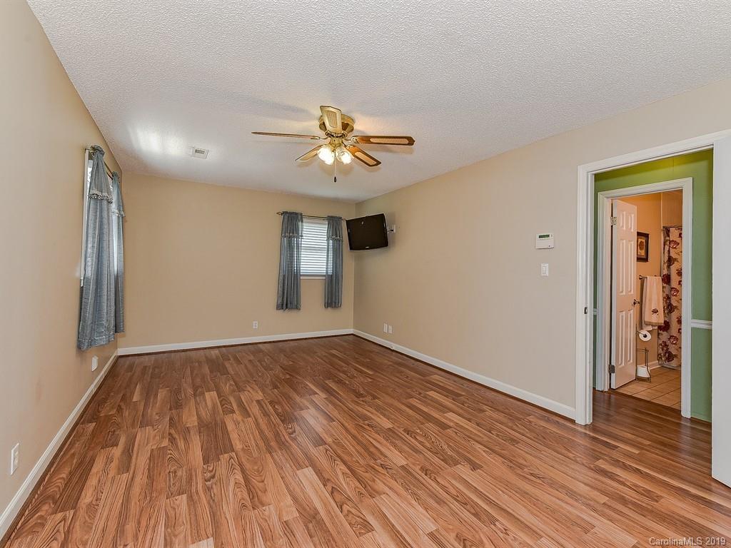 507 Sikes Mill Road Monroe, NC 28110 - Photo 22 of 40 wooden floor in an empty room with a window