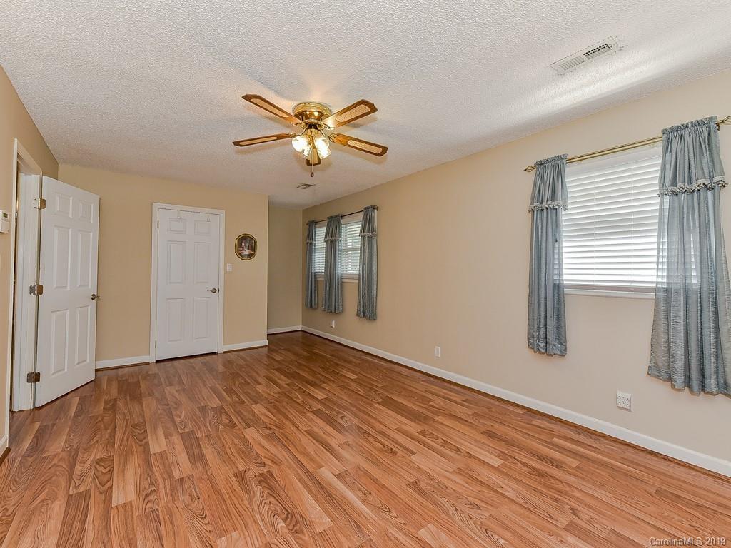 507 Sikes Mill Road Monroe, NC 28110 - Photo 24 of 40 a view of empty room with wooden floor and fan