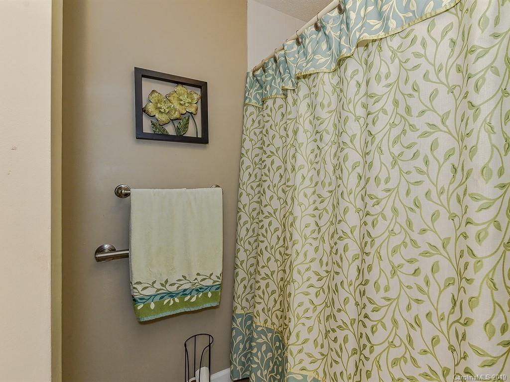 507 Sikes Mill Road Monroe, NC 28110 - Photo 29 of 40 a bathroom with a shower curtain and a shower curtain