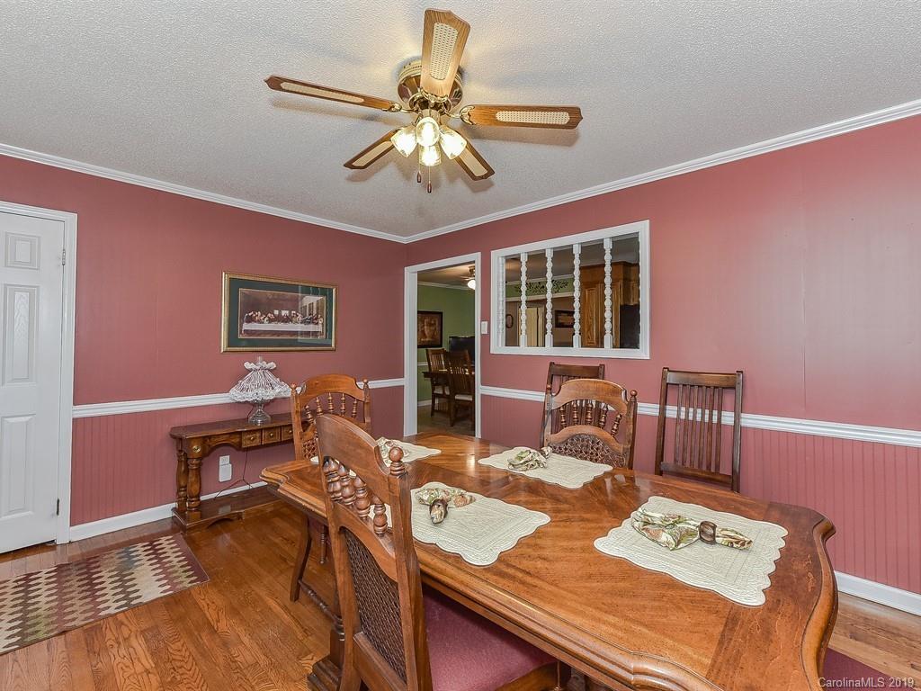 507 Sikes Mill Road Monroe, NC 28110 - Photo 10 of 40 a view of a dining room with furniture a chandelier and wooden floor