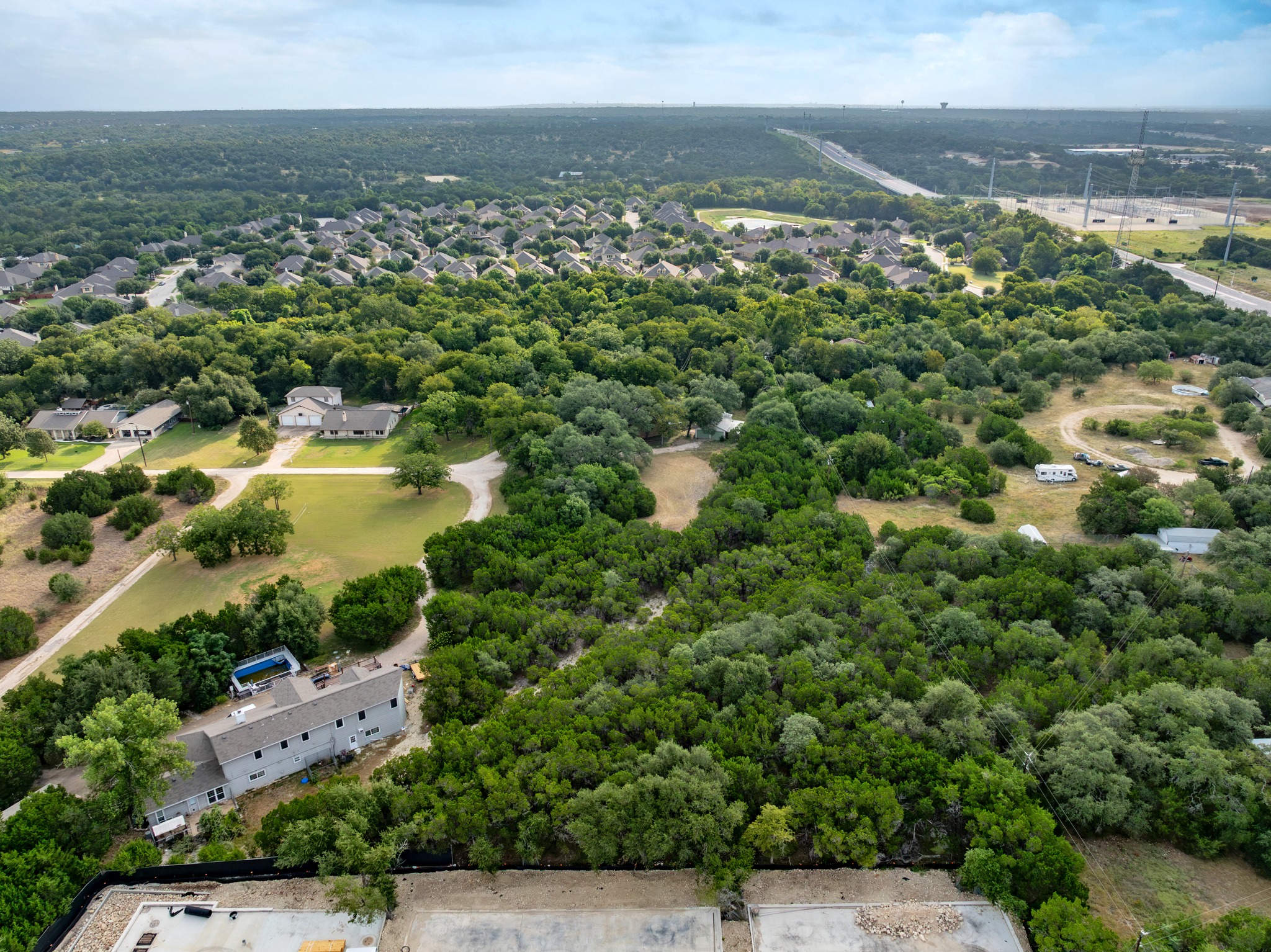 5021 Little Valley Road Leander, TX 78641 - Photo 20 of 32 High aerial context view of wooded surroundings, and nearby development.