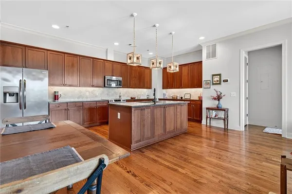 a living room with furniture a flat screen tv and a table