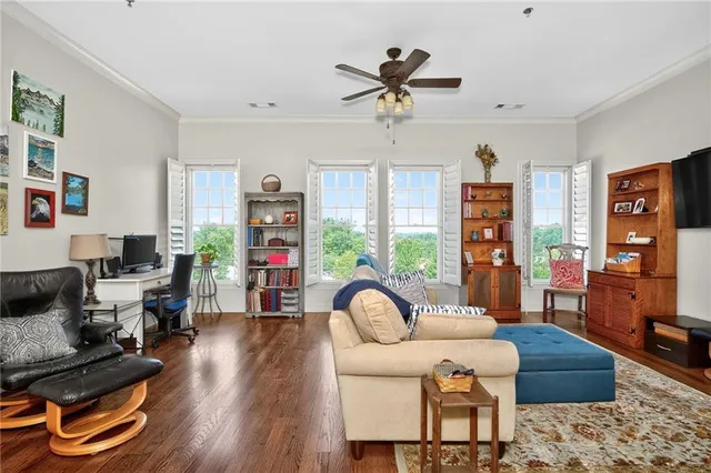 a living room with furniture kitchen view and a chandelier