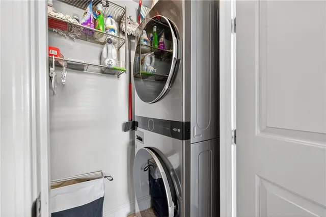 a spacious bedroom with a bed a chandelier and large window