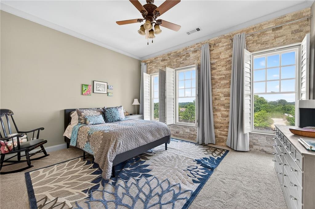 360 Chambers Street, Unit 402 Woodstock, GA 30188 - Photo 20 of 37 a spacious bedroom with a bed a chandelier and large window