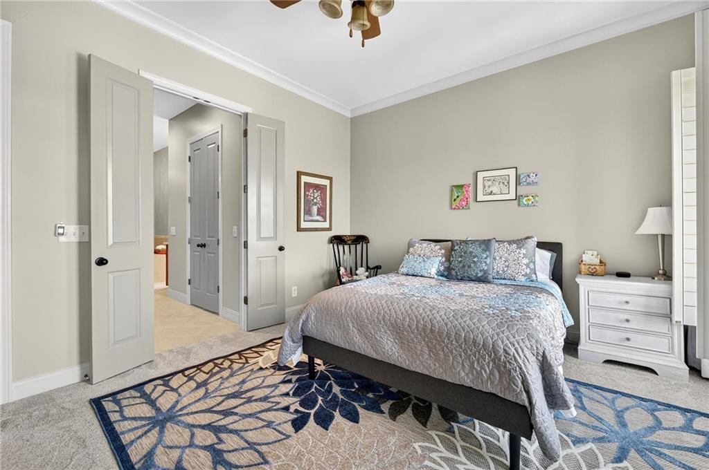 360 Chambers Street, Unit 402 Woodstock, GA 30188 - Photo 21 of 37 a bedroom with a bed and a chandelier
