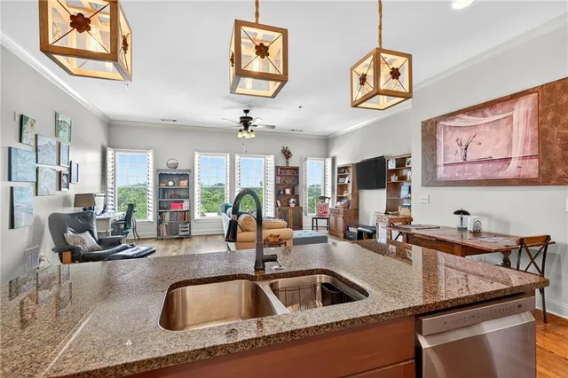 a kitchen with stainless steel appliances granite countertop a sink a stove microwave and cabinets