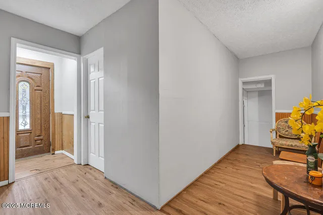 a view of a bedroom with wooden floor