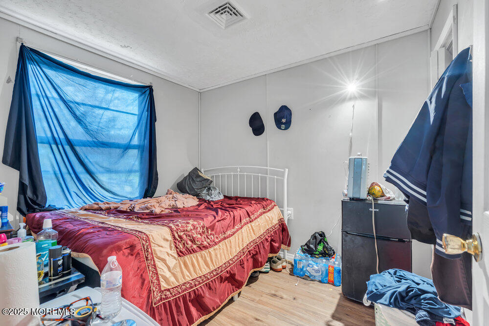 270 Alexander Avenue Howell, NJ 07731 - Photo 22 of 35 a bedroom with a bed and wooden floor