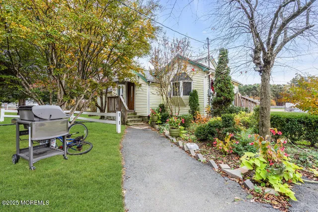 a front view of a house with a yard and sitting area