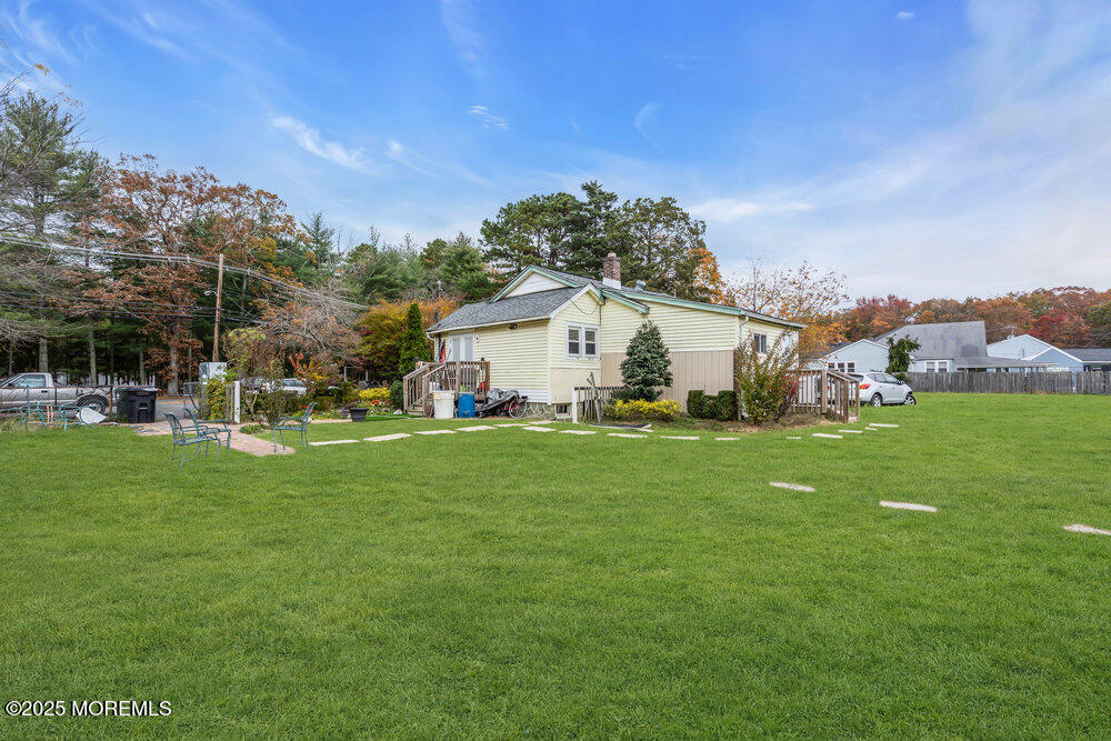 270 Alexander Avenue Howell, NJ 07731 - Photo 9 of 35 a view of a white house in front of a big yard with plants and large trees