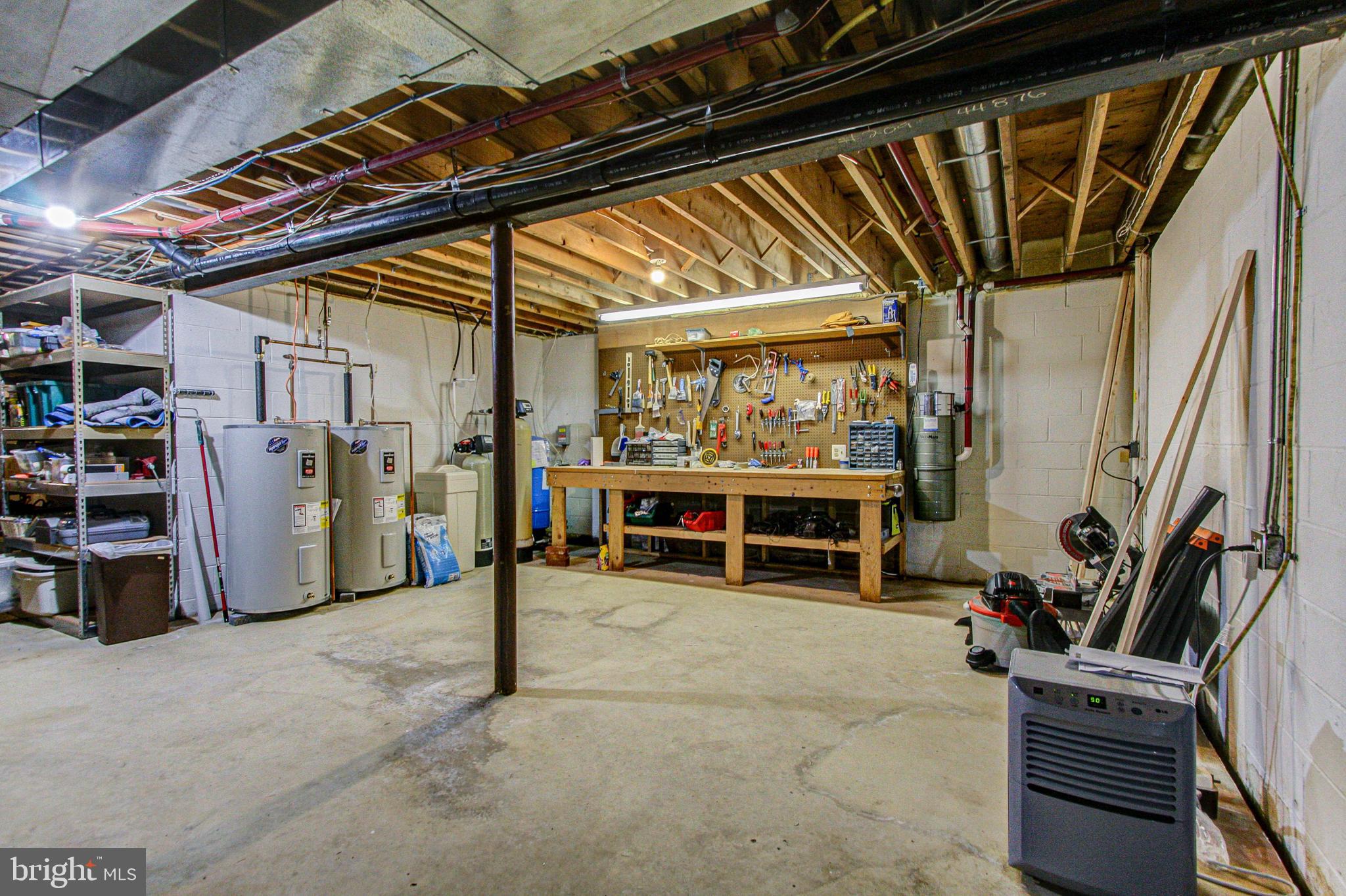 4040 Ruckman Way Doylestown, PA 18902 - Photo 35 of 48 Work bench and 2 new water heaters