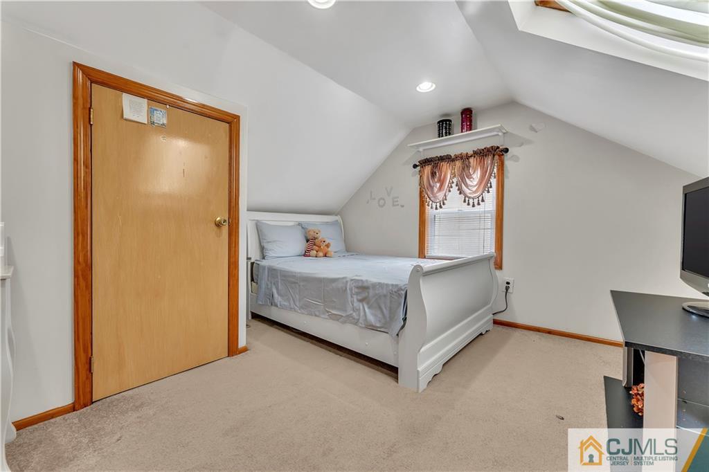121 Highfield Road Colonia, NJ 07067 - Photo 13 of 23 a bedroom with a bed and a lamp on table