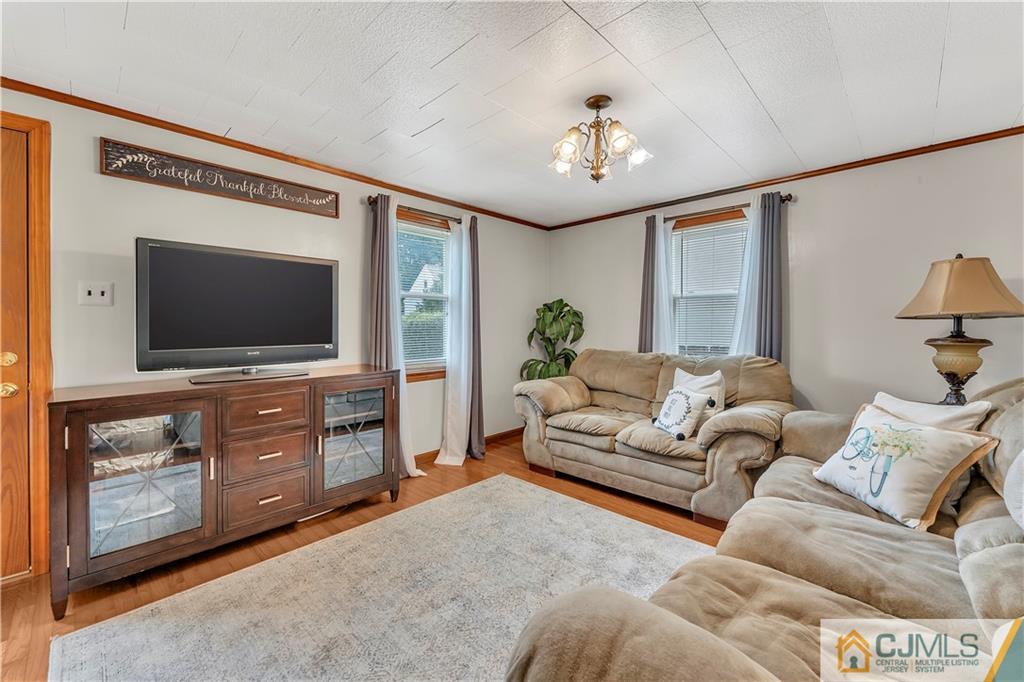 121 Highfield Road Colonia, NJ 07067 - Photo 4 of 23 a living room with furniture and a flat screen tv