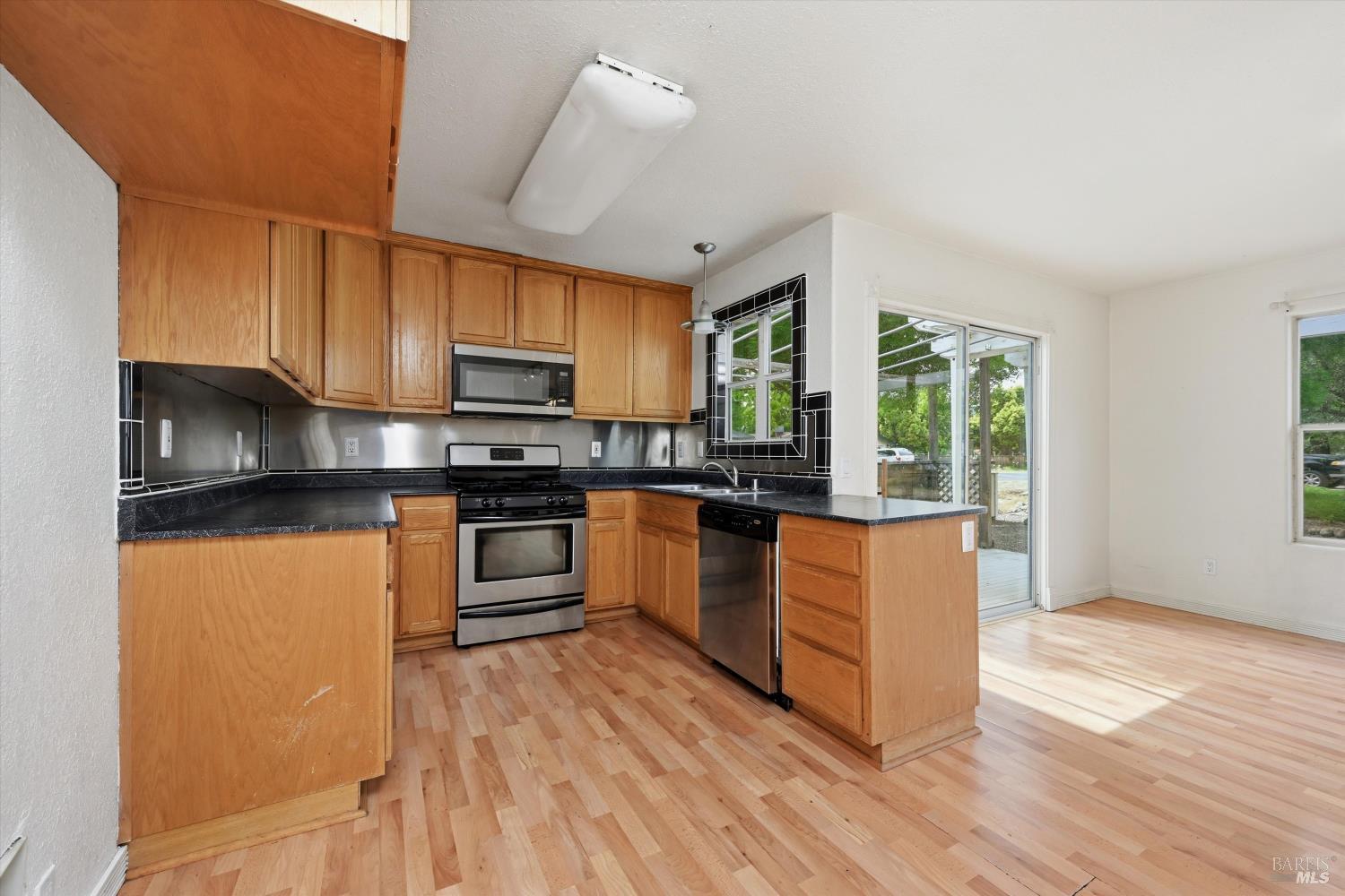 18057 Spyglass Road Hidden Valley Lake, CA 95467 - Photo 11 of 29 Kitchen looking toward dining area and slider to deck.