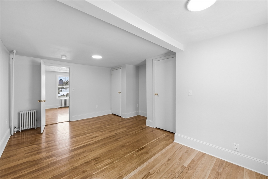 22 Douglas Avenue, Unit 1 Maynard, MA 01754 - Photo 11 of 19 a view of empty room with wooden floor