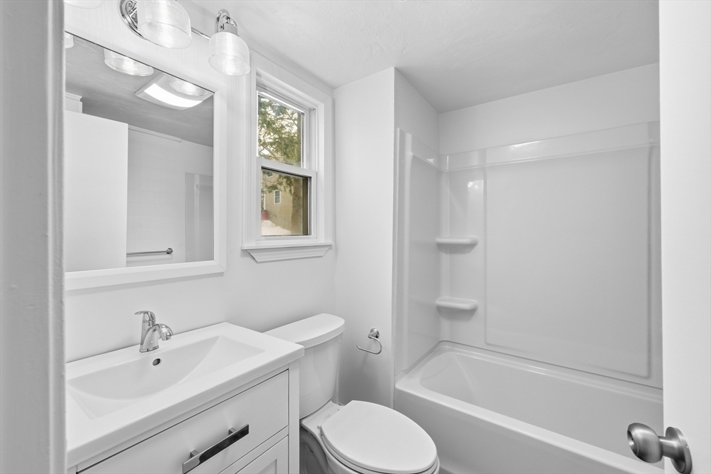 22 Douglas Avenue, Unit 1 Maynard, MA 01754 - Photo 15 of 19 a bathroom with a sink toilet and shower
